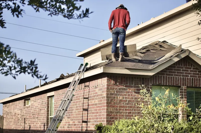 Professional roofer working on a residential roof in The Greater Corona Village